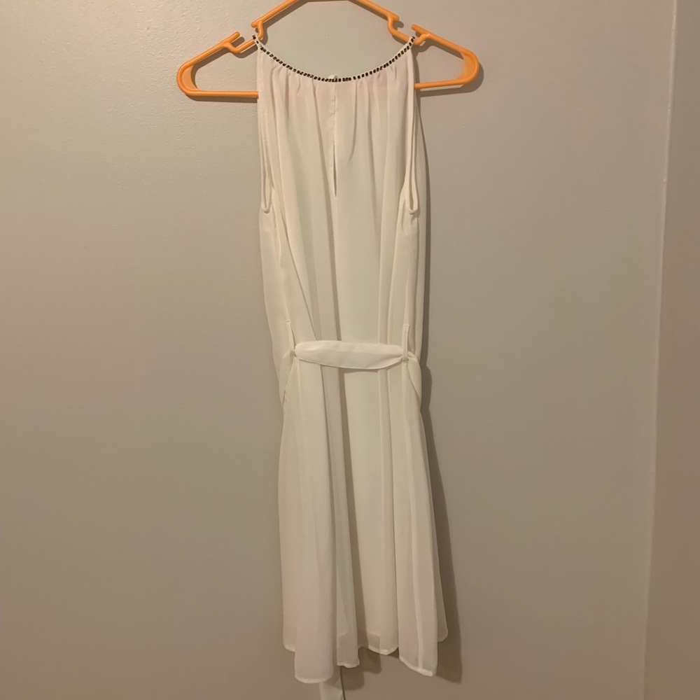 White dress with embellishments on the neckline.